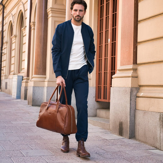 A brown leather Arsante Weekend Mini business bag, with a full-access zipper closure and small zip pocket for important items, perfect for weekend or business trips.